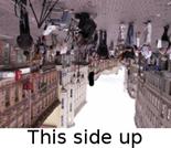 A photo of a city, rotated by 180 degrees. Caption on the bottom reads 'this side up'