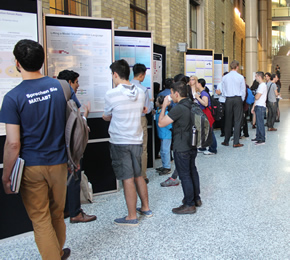 Students look at posters at Undergraduate Research Showcase