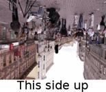 a photo of a city, rotateted by 180 degrees. Caption on the bottom reads 'this side up'